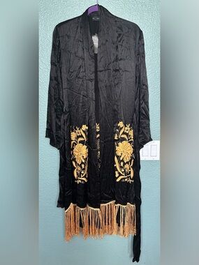 SFERA  black kimono featuring gold floral embroidery and fringed detailing.